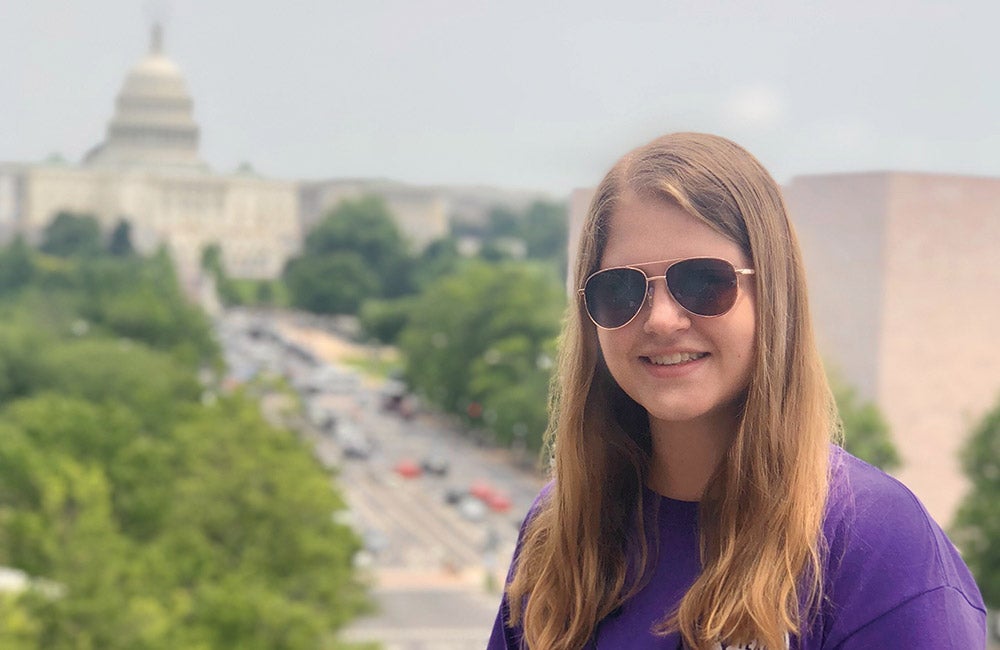 Morgyn Granville, Central Texas EC, atop the Newseum with the U.S. Capitol in the background.